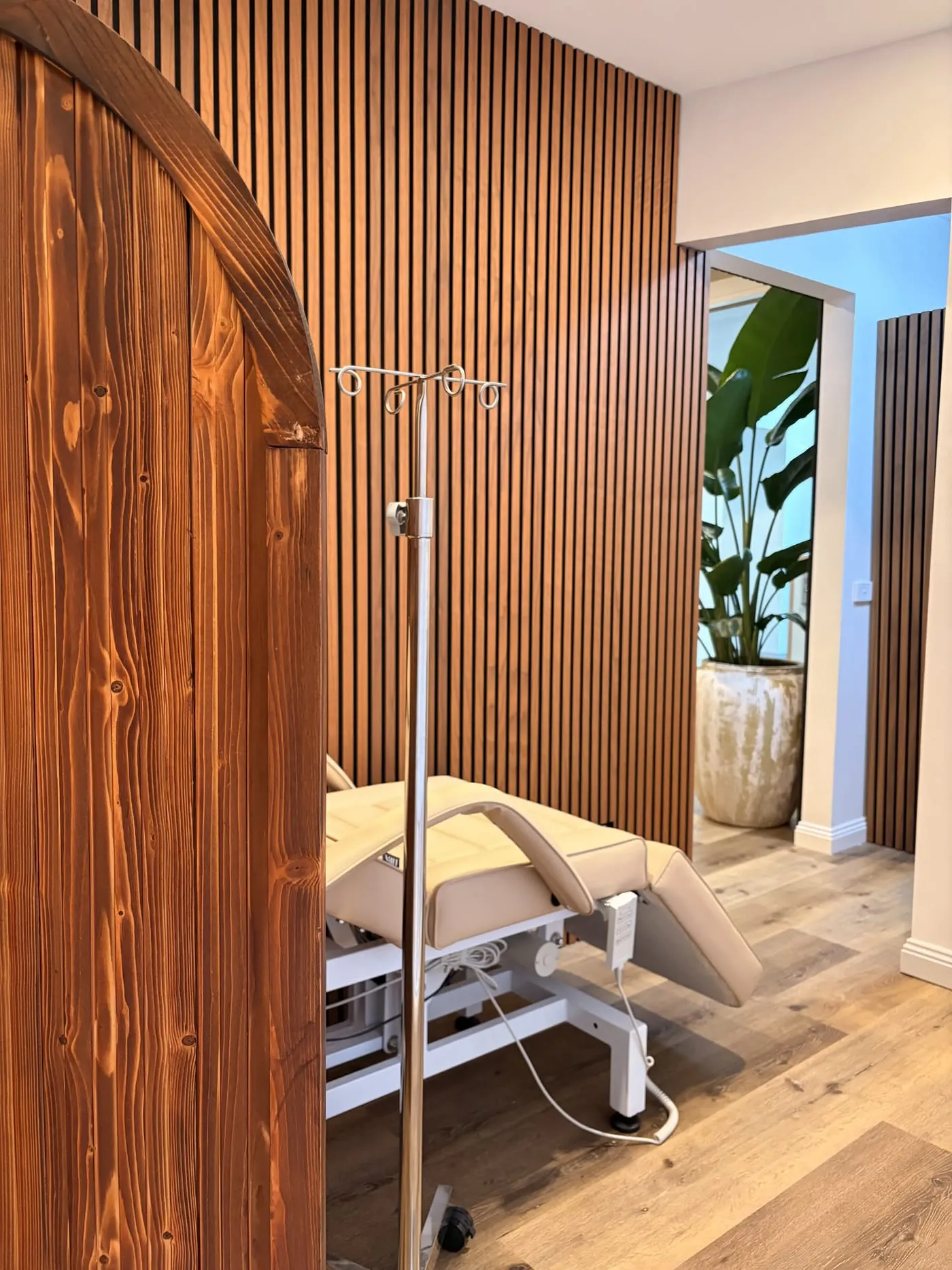 The infusion suite at The Skin Doctor, with a treatment recliner and IV stand in a calm, naturally lit space