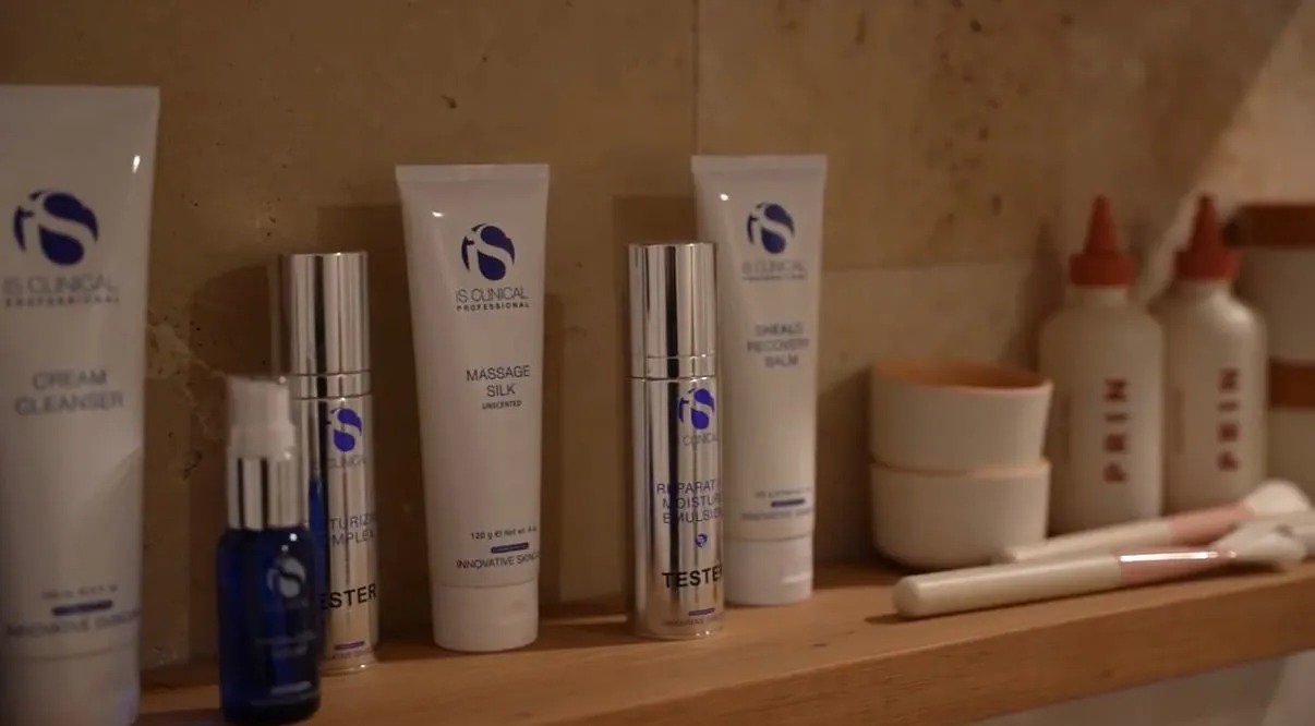 Medical-grade skincare and folded towels styled on a stone surface at The Skin Doctor