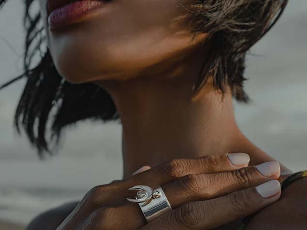 A woman with dark complexion touching her shoulder is in lower risk for skin cancer