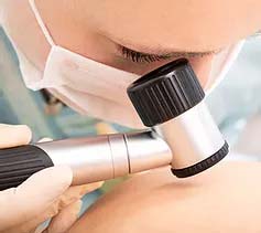A skin specialist looking for spots of skin cancer in a skin cancer clinic in Melbourne